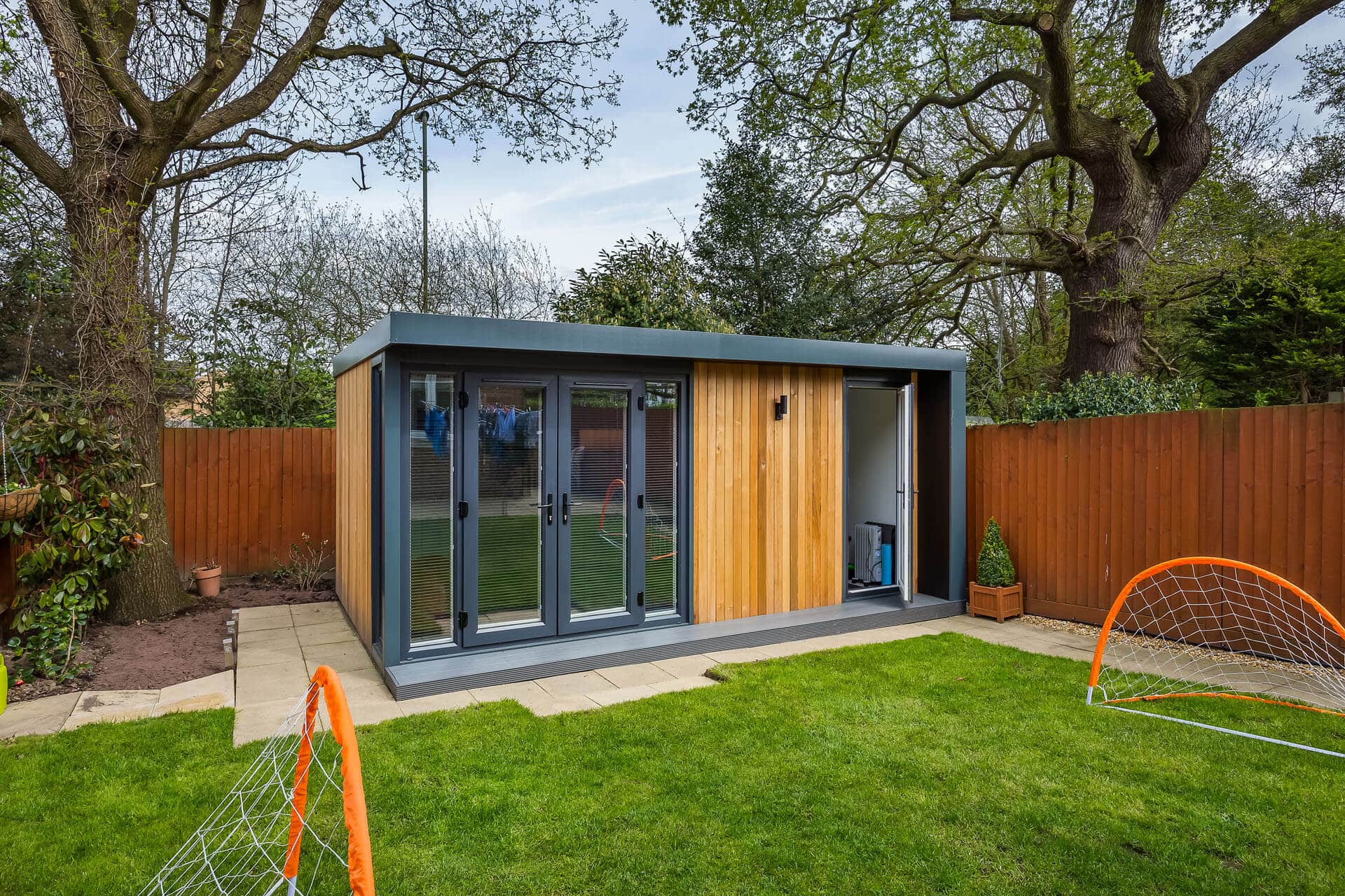 luxury garden outbuilding with side storage and pop up football goals