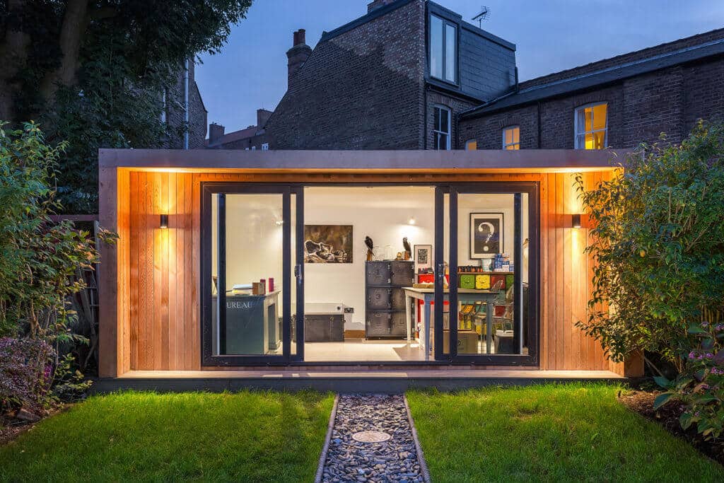 garden office playroom in the evening with outdoor lighting