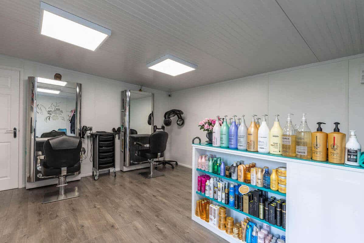 The inside of a home hair salon with haircare products & hairdressing equipment