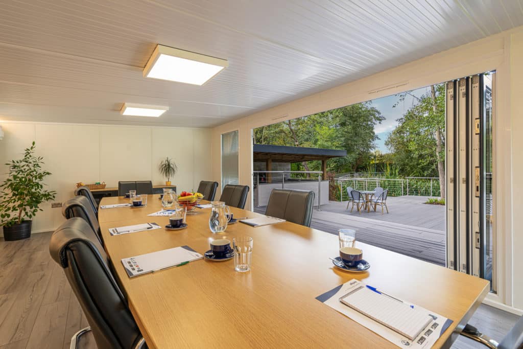 Interior of a boardroom looking out onto a patio and landscaped garden
