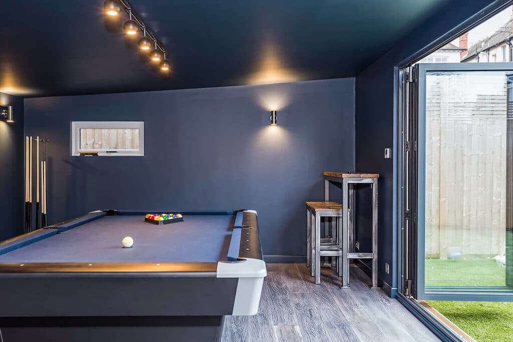 navy painted garden bar with pool table