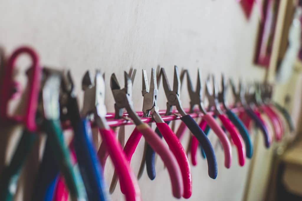 Close up on tools on a pink rack.