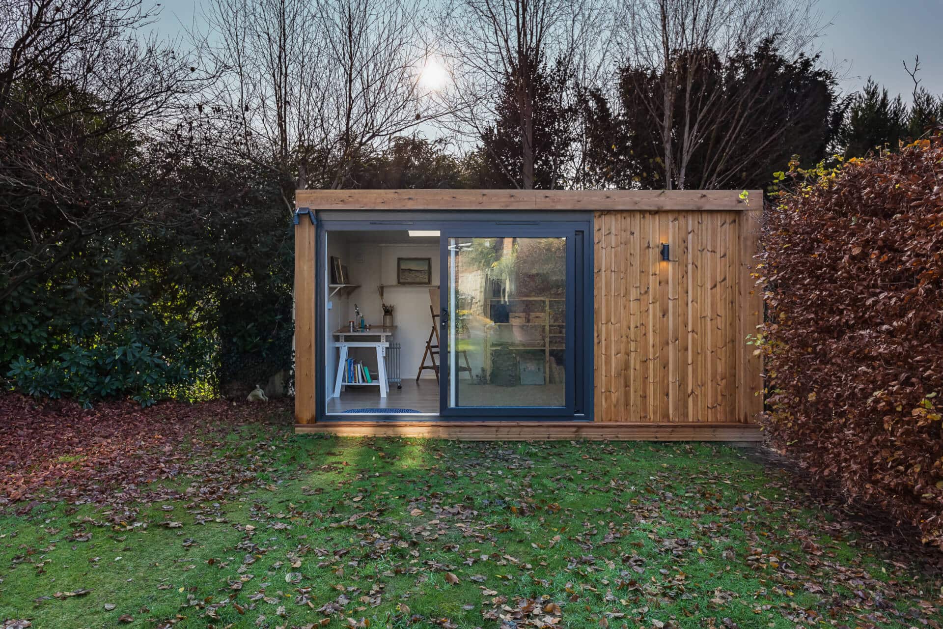 Green Retreats garden cabin office in Autumn with sliding door open