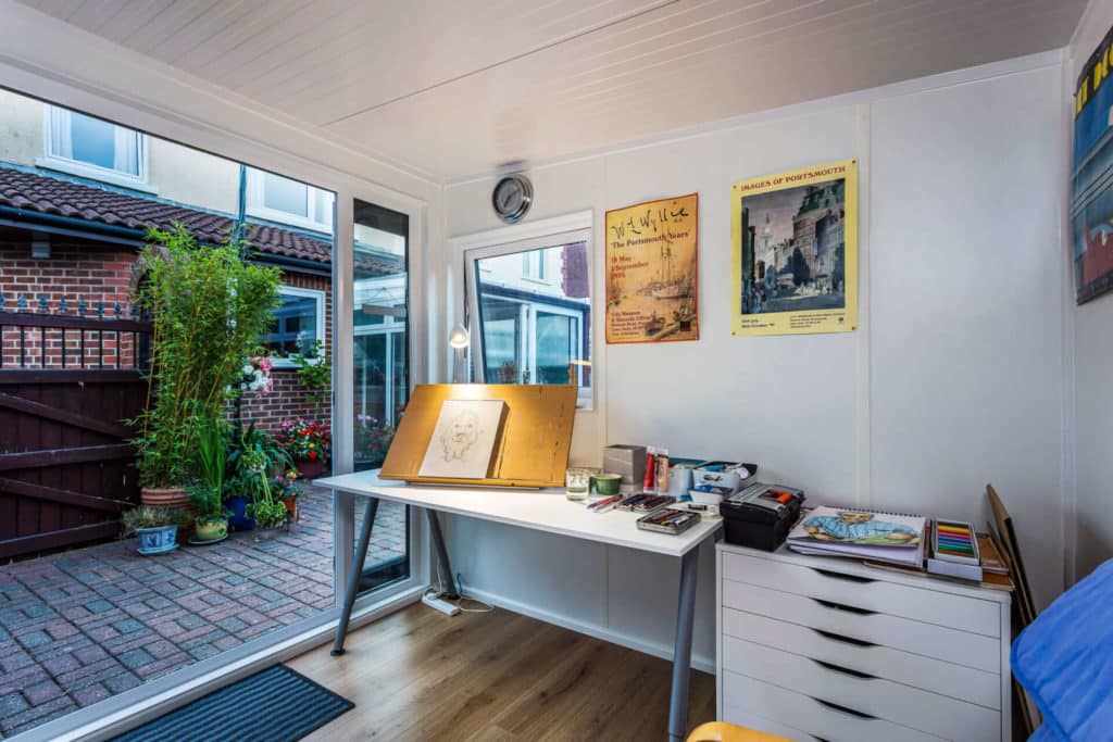 Green Retreats garden studio with artwork and open doors