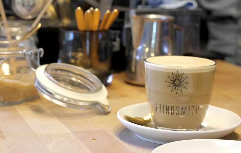 grindsmith logo latte on table