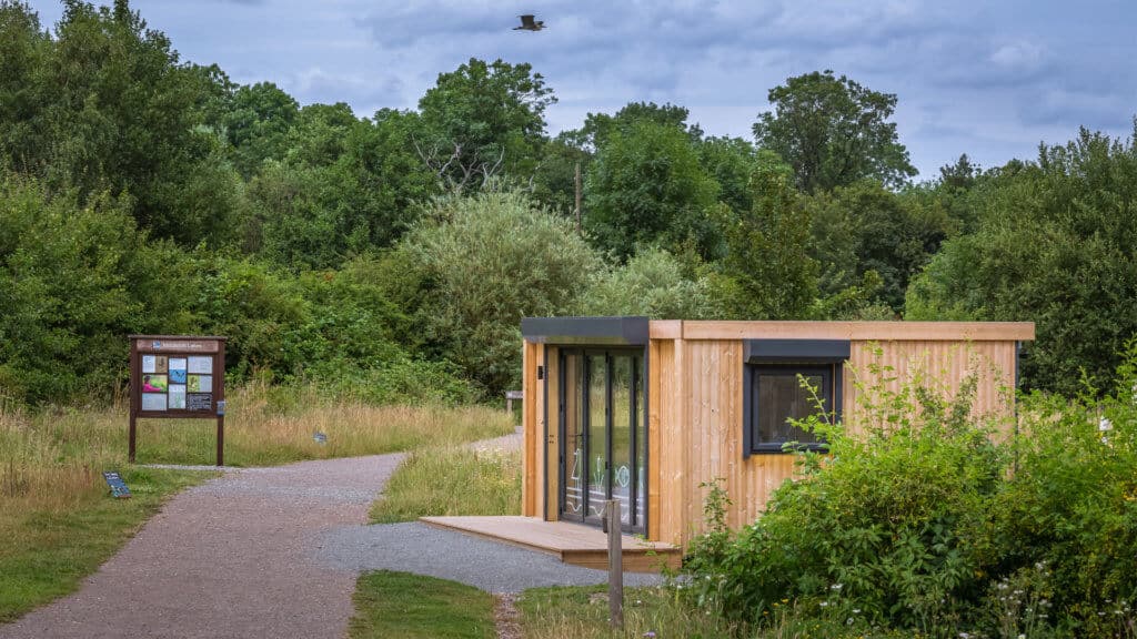 Exterior of an Inspiration used as RSPB welcome hub with bushes in the foreground