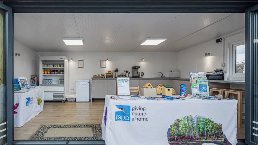Exterior of an Inspiration used as RSPB welcome hub with a table with flyers on it