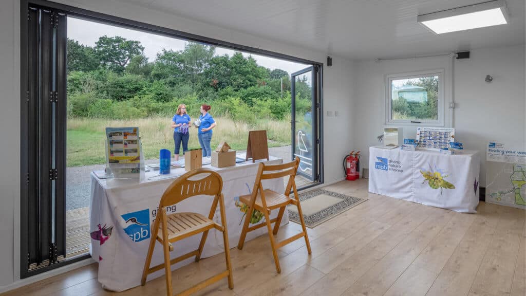 Interior of an Inspiration used as RSPB welcome hub with a table with flyers on it