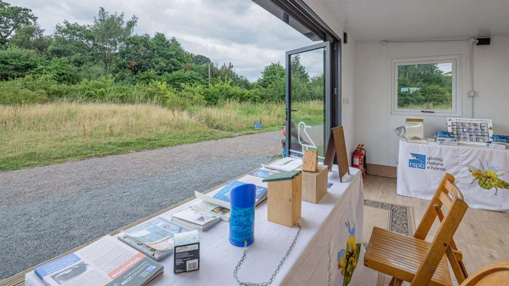 Interior of an Inspiration used as RSPB welcome hub with a table with flyers on it