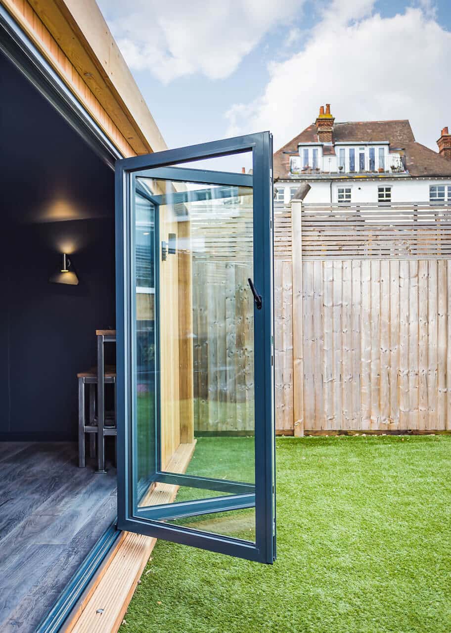 graphite bifold doors opening into garden game room