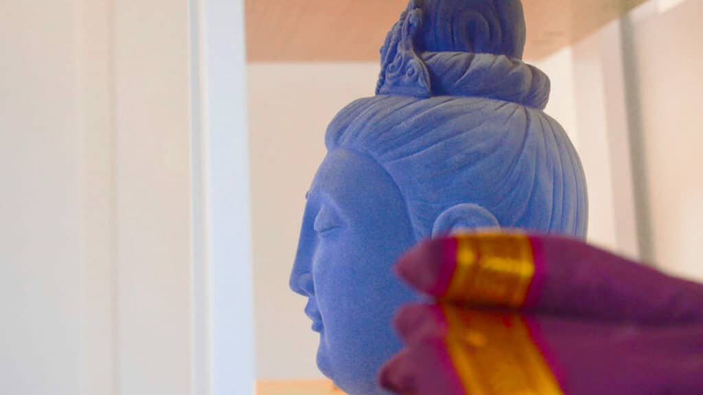 A buddha head with some fabric to the side