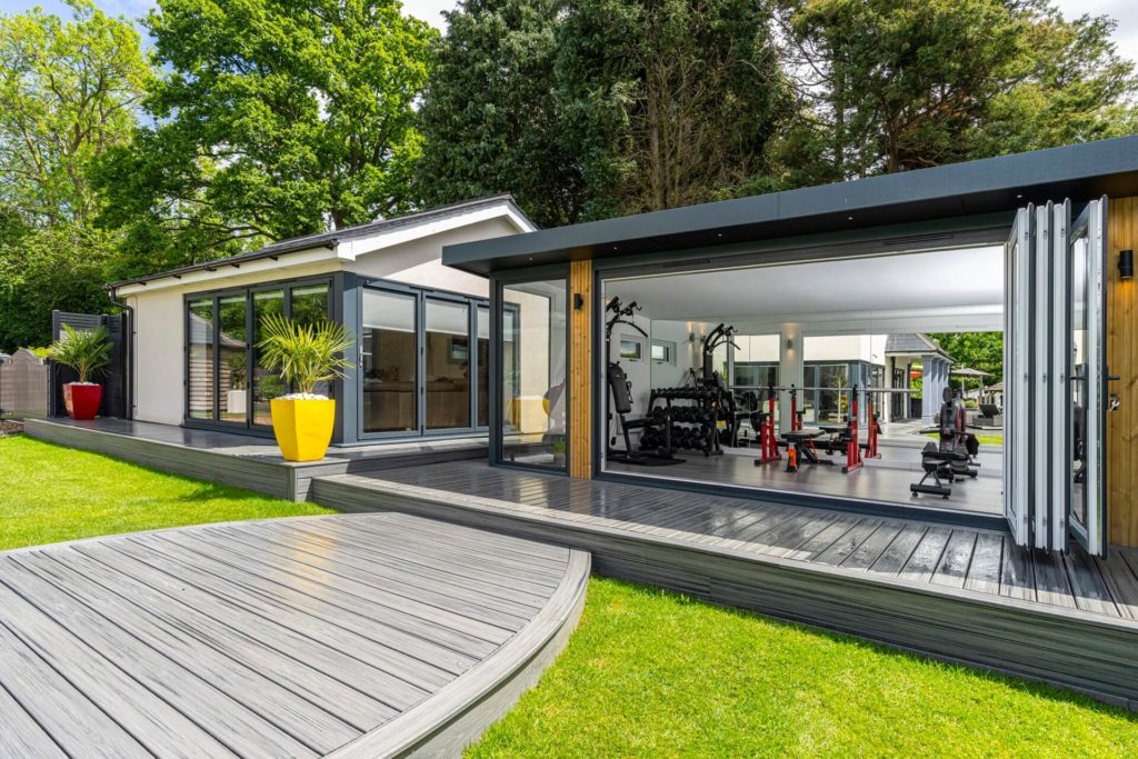 Single angle view of garden gym with built around composite, grey decking