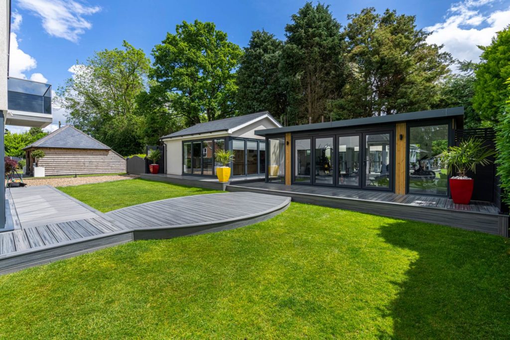 Garden room set in large garden with composite decking linking the garden room, other outbuilding and house