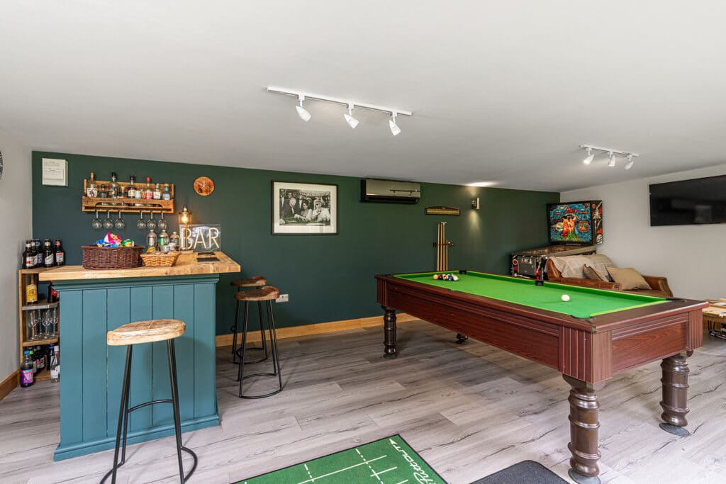 interior of a garden games room with pool table and bar