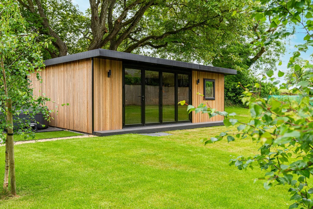 landscape image of a garden games room with the bi-folding doors closed