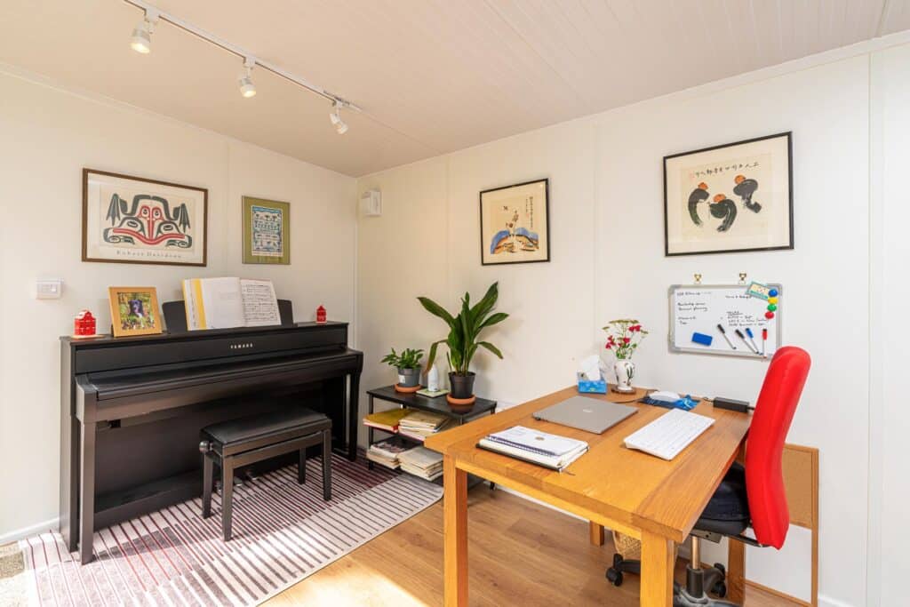 Piano in garden room with office desk set-up