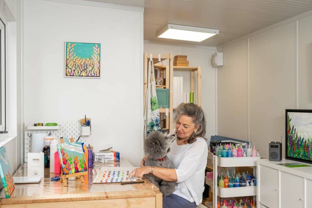 customer with her dog sitting in a garden art room