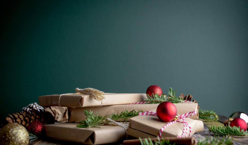 Christmas presents wrapped in kraft paper with baubles