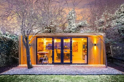 illuminated garden room in the winter with snow