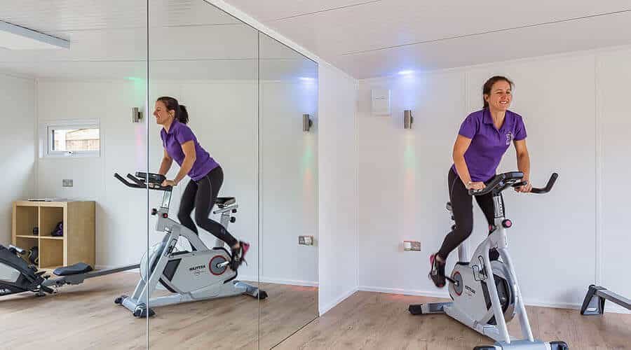 woman on exercise bike in mirror