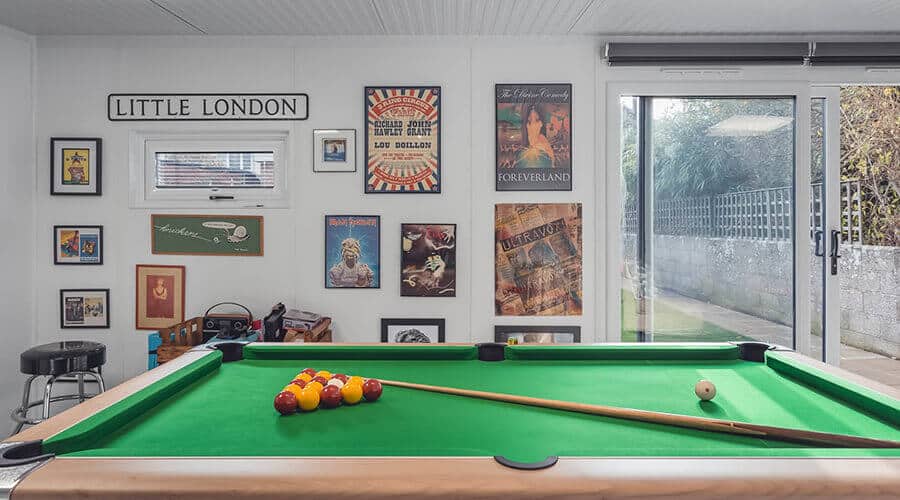 pool table with pictures hanging on the wall