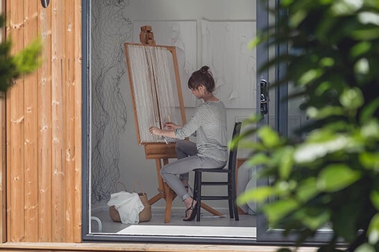 Artist working in her Green Retreats garden studio