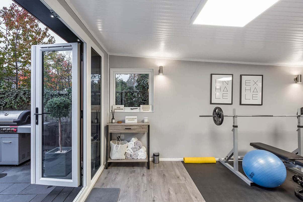 Home gym with a bench press, towels & exercise ball